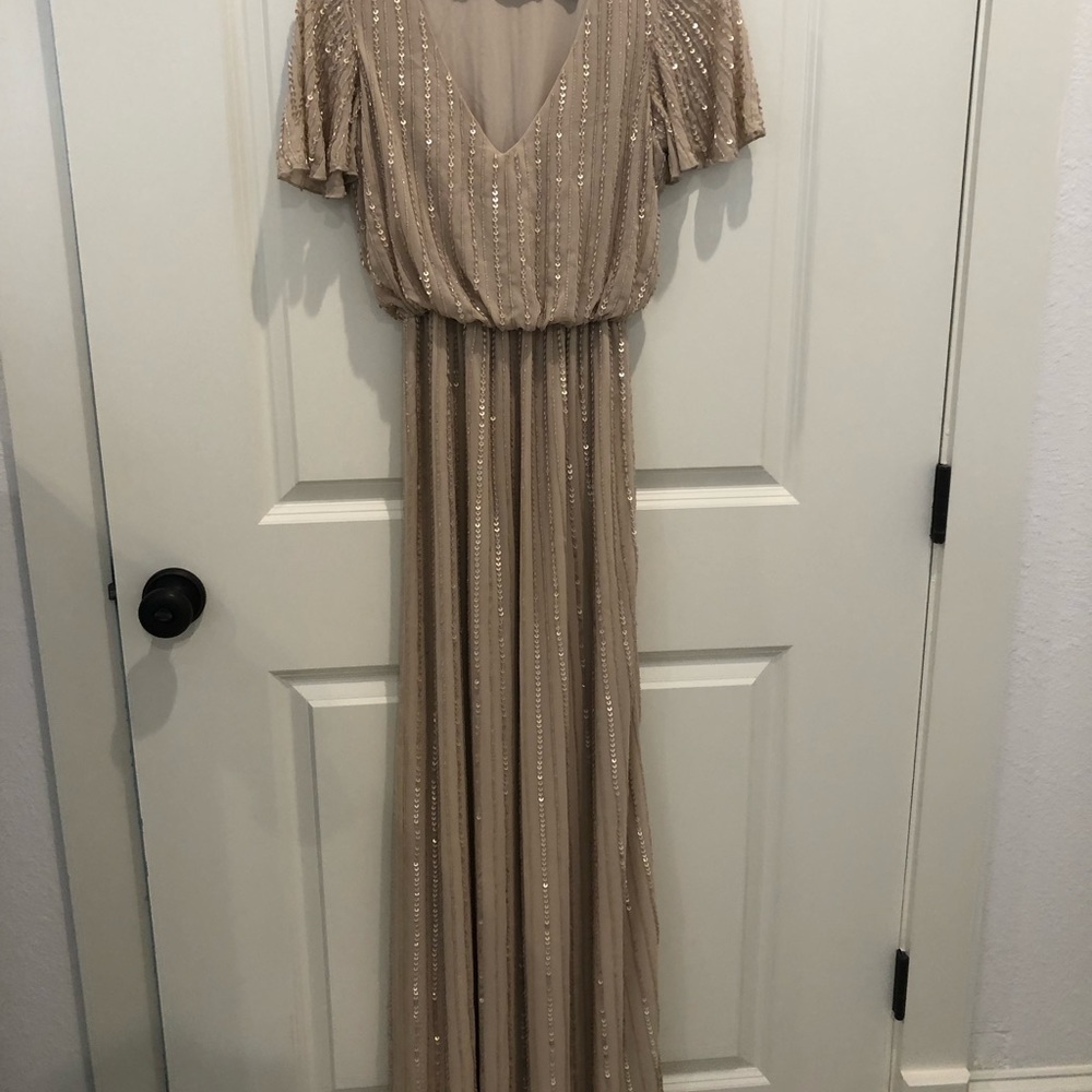 Beaded. Never altered. I’m a size 4 & 5’6 and wear a small. XS fit perfectly.